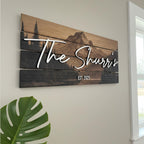 Custom last name sign with layered mountain ridge design on wood