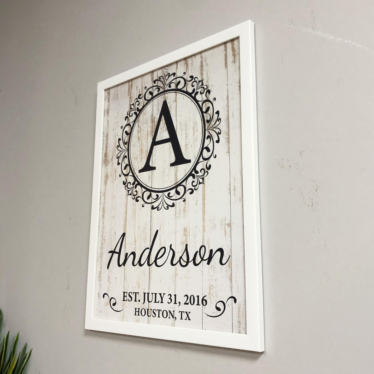 Custom monogram family sign packaged as a housewarming gift