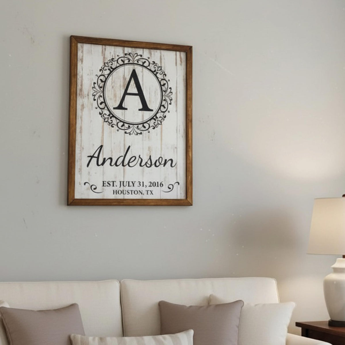 Custom family name wood sign with a large center initial for an entryway