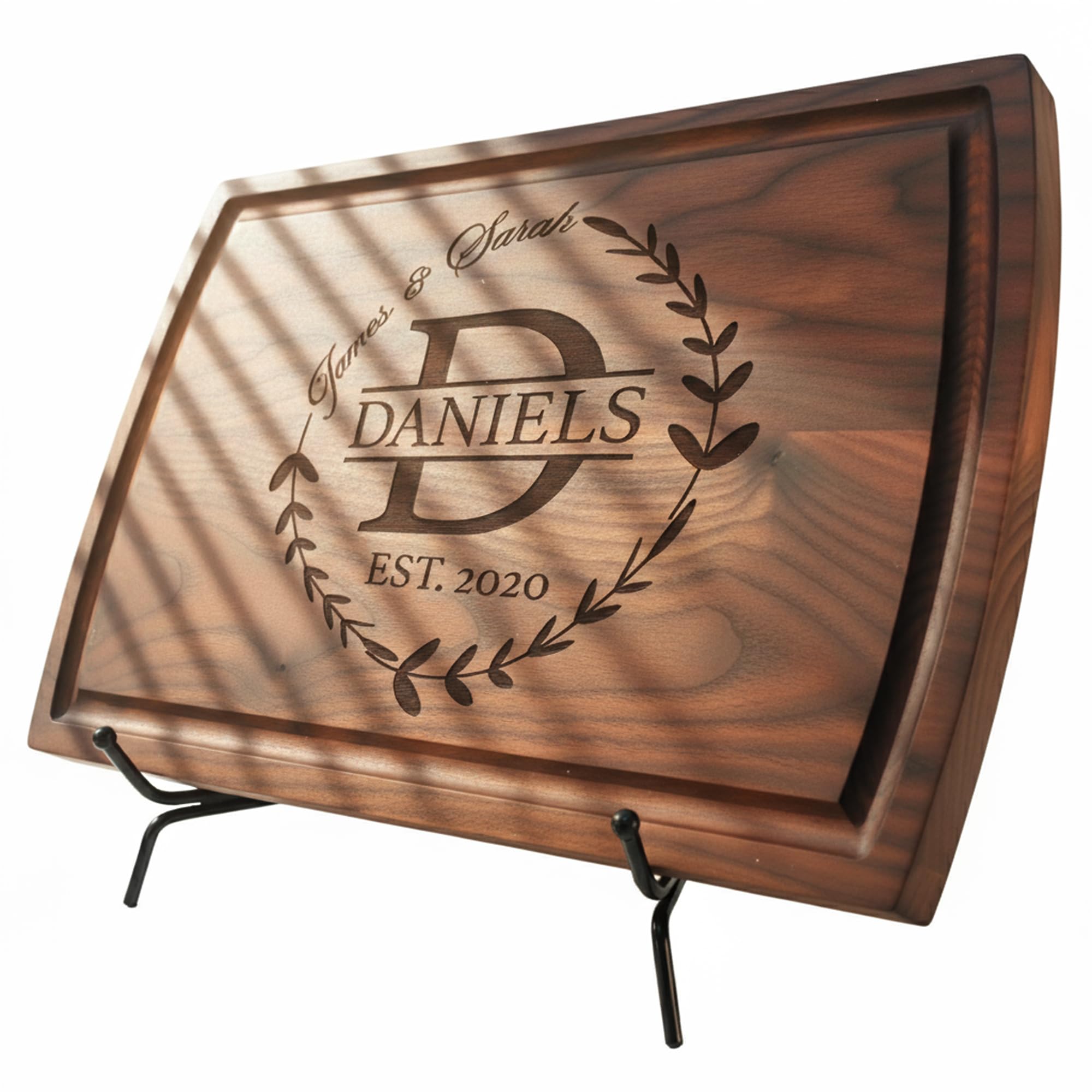 Personalized cutting board engraved with a family name and established year